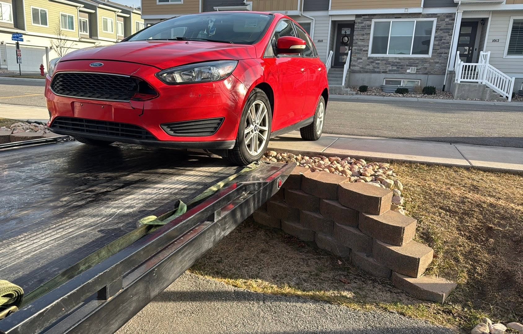 Hauling Ace Towing loading a car from a driveway in Erda, Utah